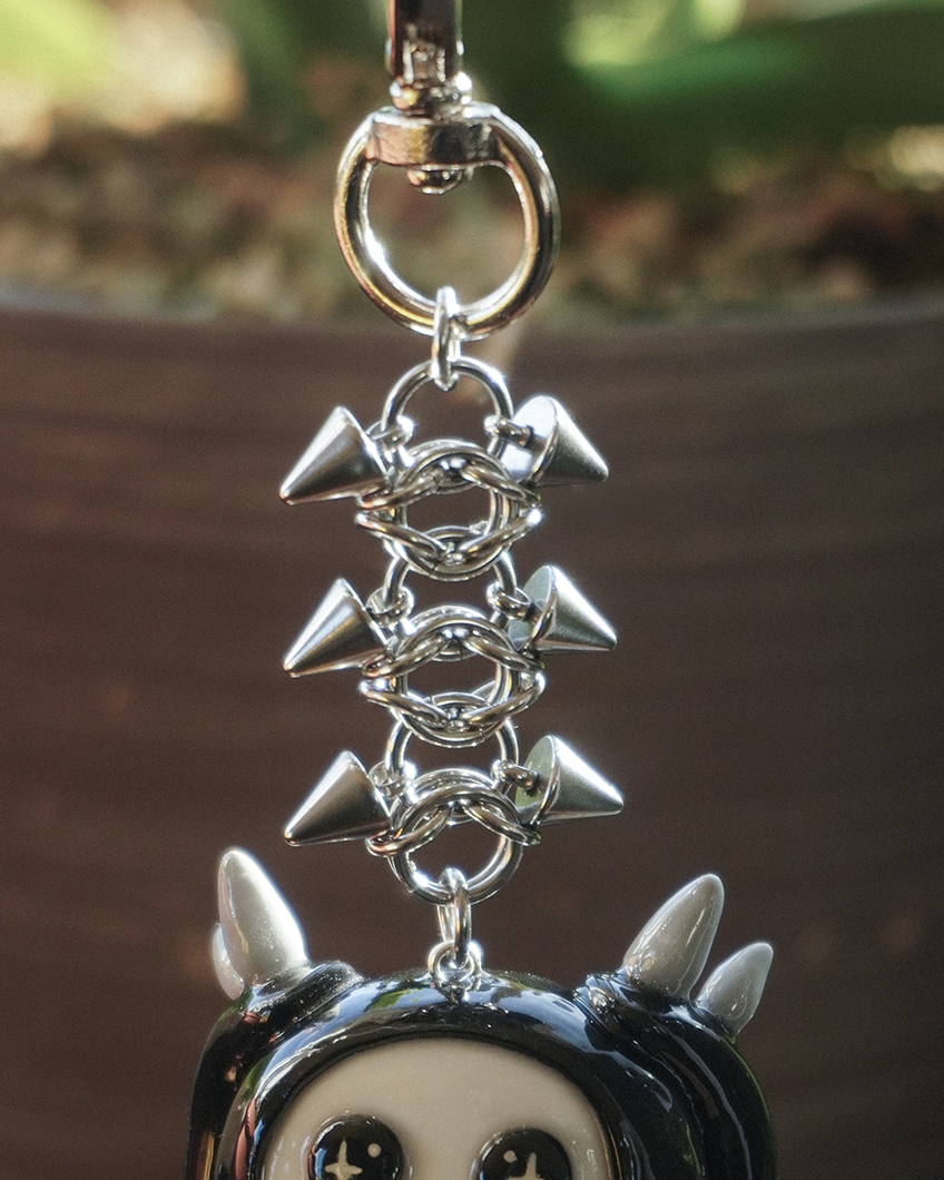 spiked keychain with a clay character design featuring spikes
